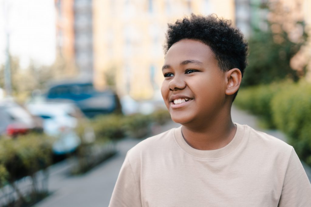 Smiling youth standing outside